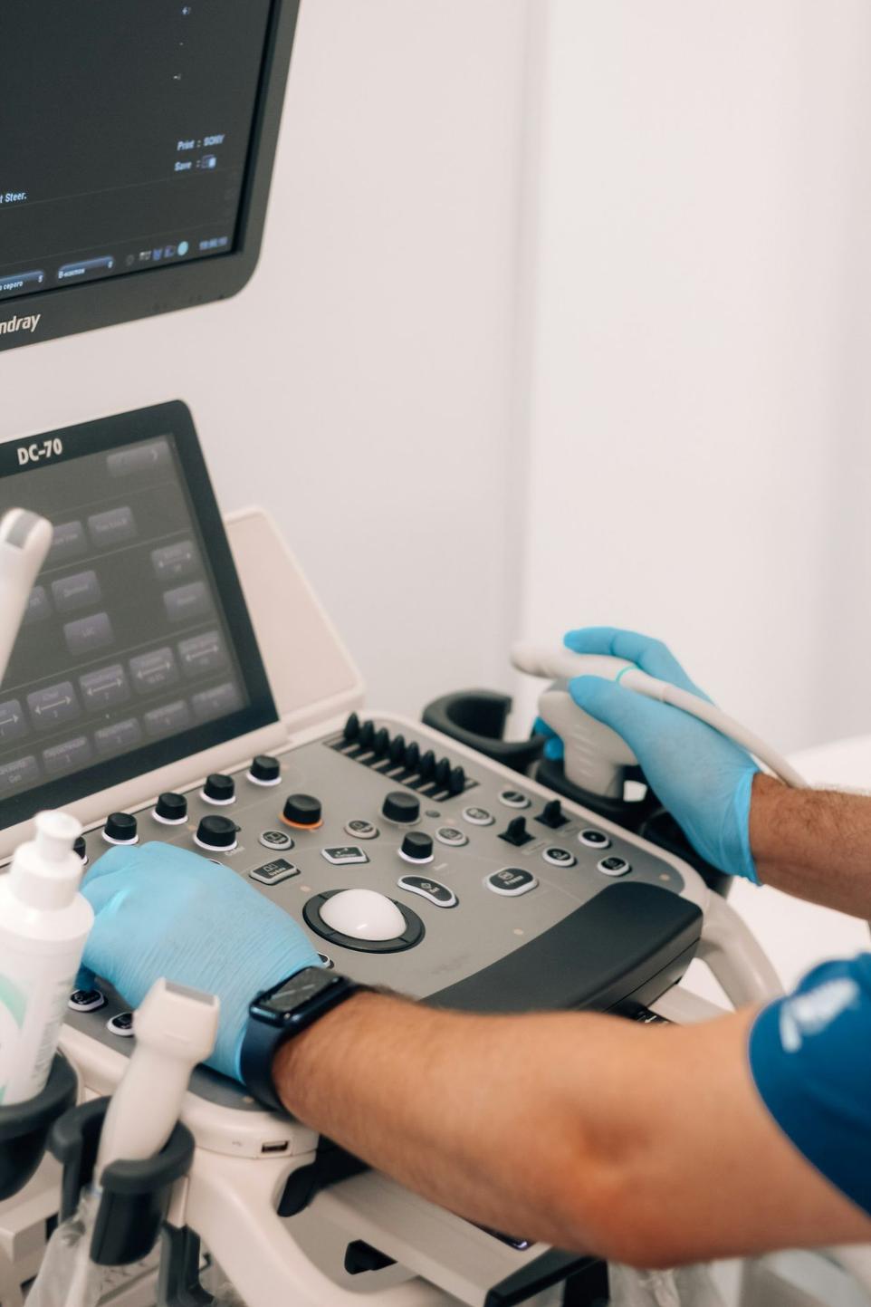 a person in blue gloves is operating a machine